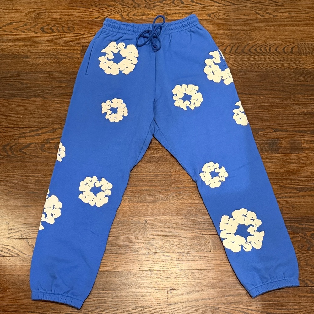 Denim Tears Blue Joggers with White Floral Design